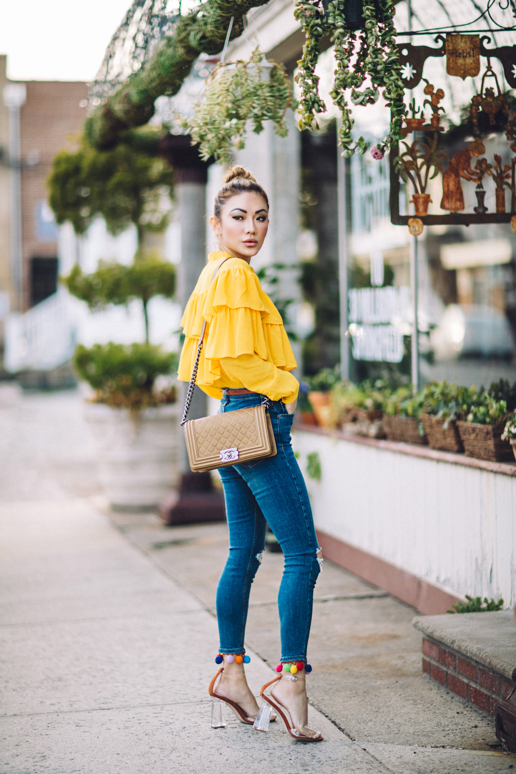 7 Posing Tips for Bloggers - Yellow ruffle top, jeans with pom pom hem // Notjessfashion.com