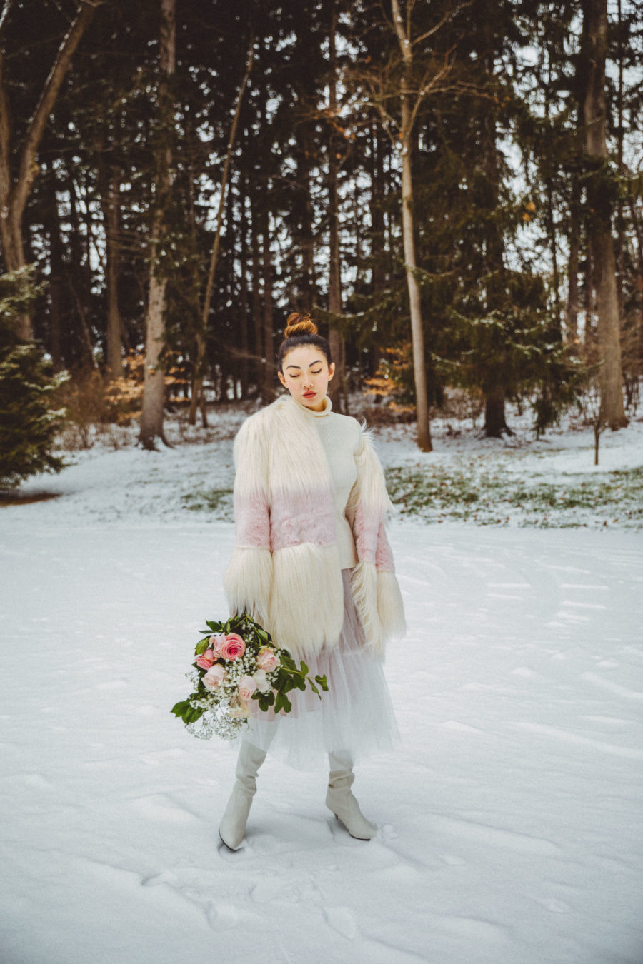 What to wear with knee high boots - White and Pink Fur Coat with Tulle Skirt and White Sweater, knee high boots // Notjessfashion.com // elegant winter outfit, dressy outfits for the snow, snow outfit, tulle midi skirt, white boots, winter white outfit, asian blogger, new york fashion blogger, winter fashion editorial