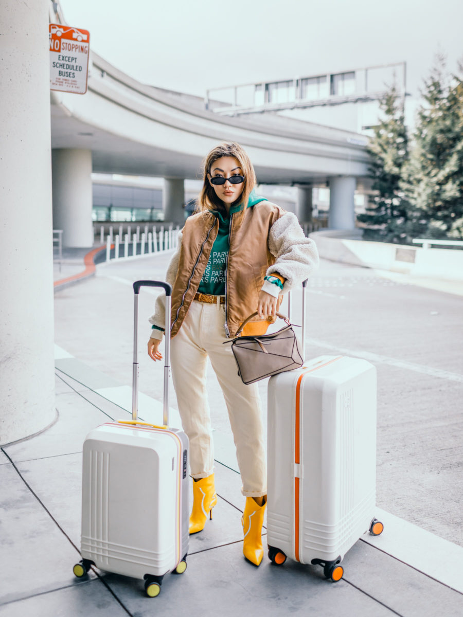 fashion blogger jessica wang shares the best winter coats and wears a shearling bomber with loewe puzzle bag and roam luggage // Notjessfashion.com
