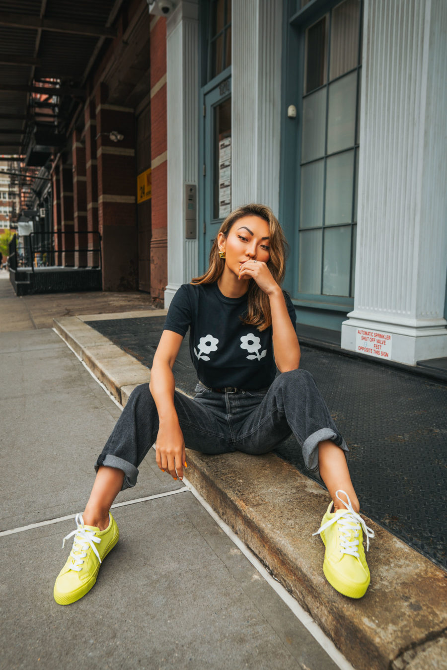 Jessica Wang wearing a graphic tee with black denim jeans and neon yellow sneakers // Jessica Wang - Notjessfashion.com