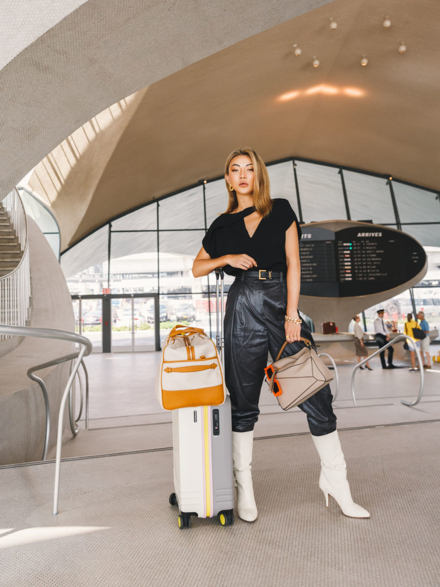 jessica wang wearing a black cut out shirt, leather pants, and white boots while sharing her favorite amazon travel essential finds // Jessica Wang - Notjessfashion.com