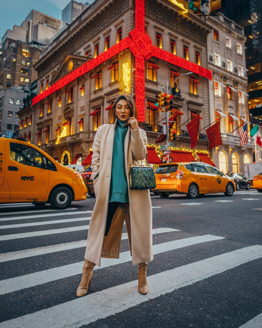 fashion blogger jessica wangs shares holiday gifts that give back and wears camel coat with green tunic and knee high boots // Notjessfashion.com