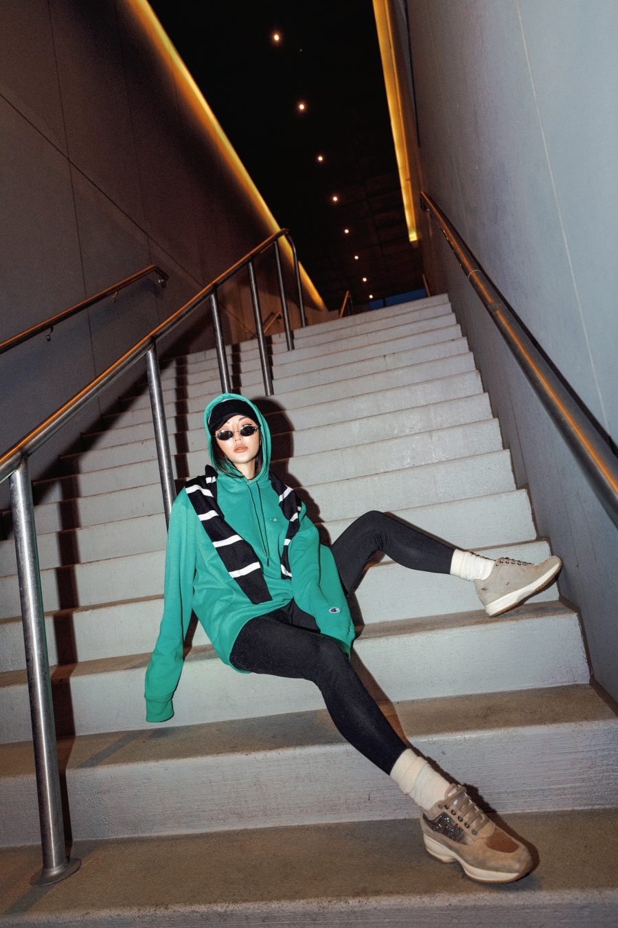 Jessica Wang wearing a turquoise hoodie with black tights, knee high socks, and sneakers // Jessica Wang - Notjessfashion.com