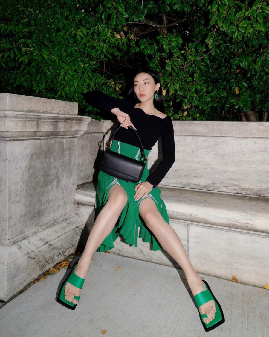 Jessica Wang trendy fall and winter handbags for 2021 with a black off the shoulder top and a green pleated midi skirt // Jessica Wang - Notjessfashion.com