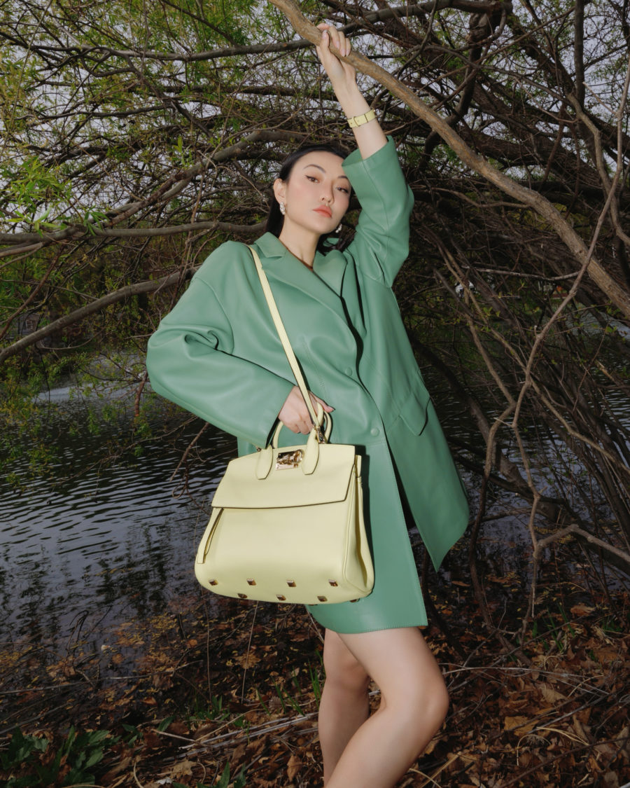 Jessica Wang wearing a green ferragamo jacket with a yellow ferragamo bag while sharing her favorite Thanksgiving outfits // Jessica Wang - Notjessfashion.com